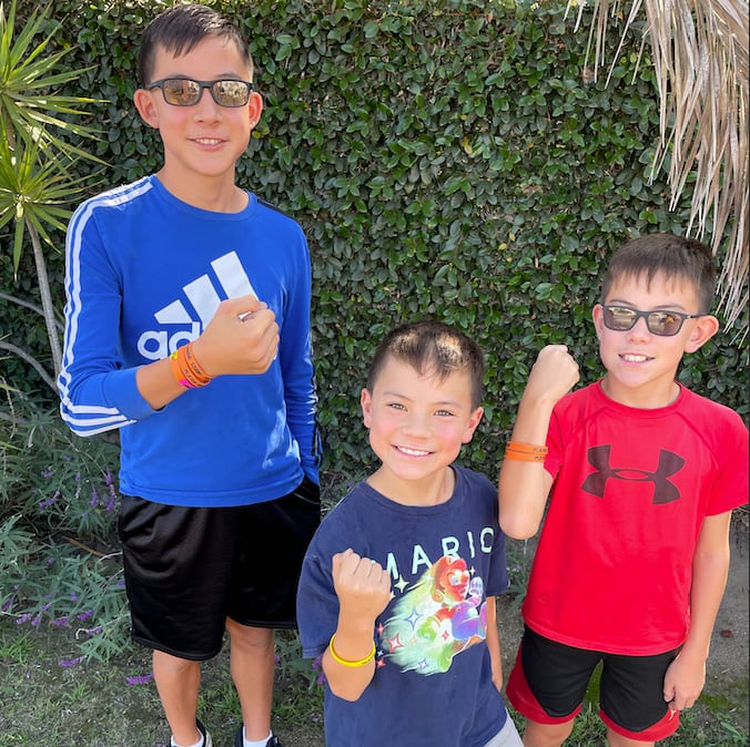 Three Player One students outside a lesson, flexing for the camera.